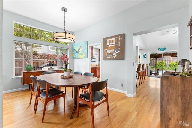 dining area featuring light wood-type flooring and baseboards
