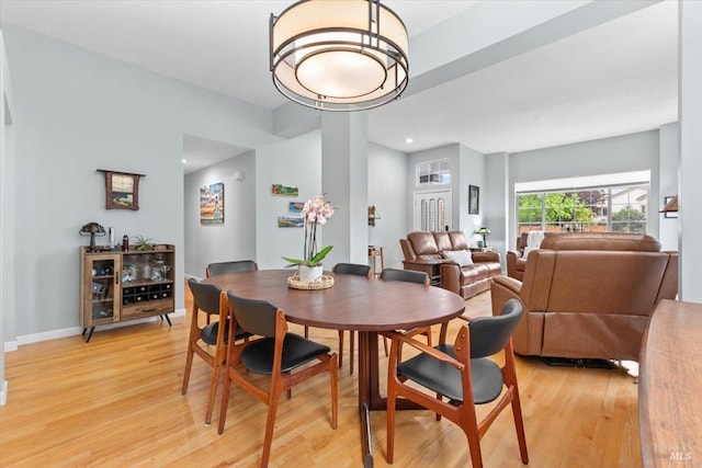 dining space featuring light wood-type flooring, recessed lighting, and baseboards