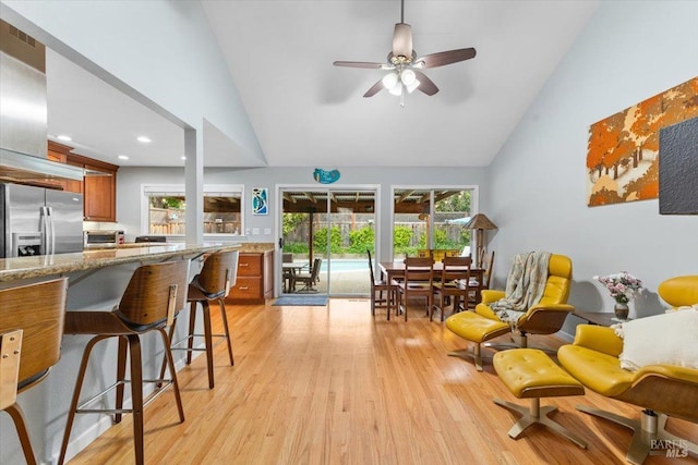 interior space featuring ceiling fan, light wood finished floors, high vaulted ceiling, recessed lighting, and a toaster
