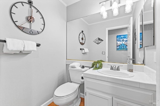 half bath featuring crown molding, toilet, and vanity