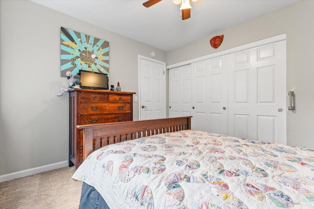 carpeted bedroom featuring a closet, a ceiling fan, and baseboards