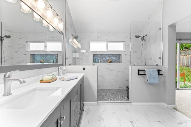 bathroom with a sink, a marble finish shower, baseboards, and marble finish floor