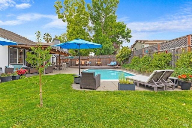 view of swimming pool featuring a fenced in pool, a fenced backyard, a patio area, and a yard