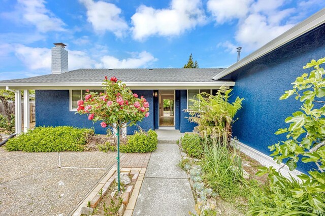 1543 Cunningham Way, Santa Rosa, CA 95403 - view of front of house with stucco siding, a chimney, and roof with shingles