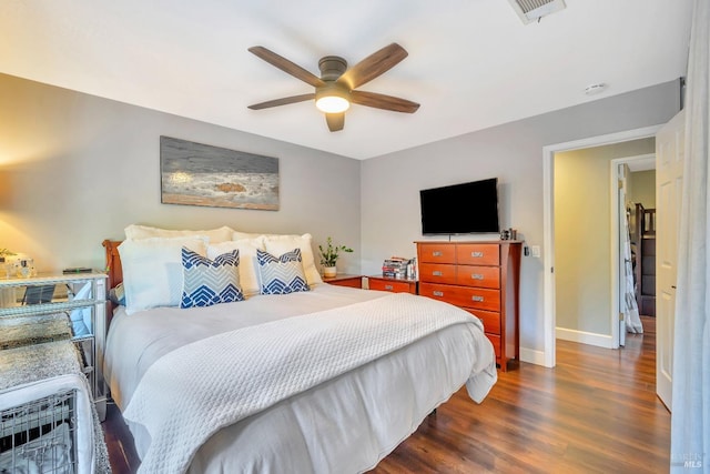 bedroom featuring visible vents, ceiling fan, dark wood finished floors, and baseboards