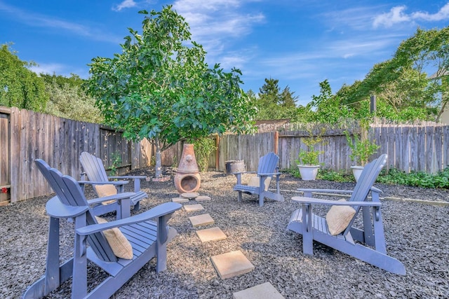view of patio featuring an outdoor fire pit and a fenced backyard