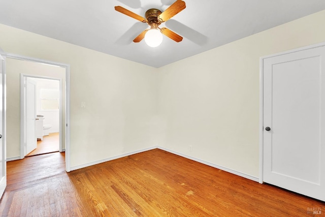 unfurnished bedroom with ceiling fan, light wood-style flooring, and baseboards