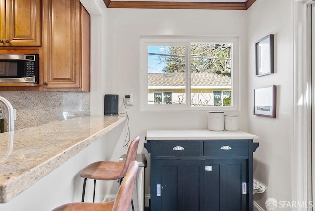 interior space with crown molding and tasteful backsplash