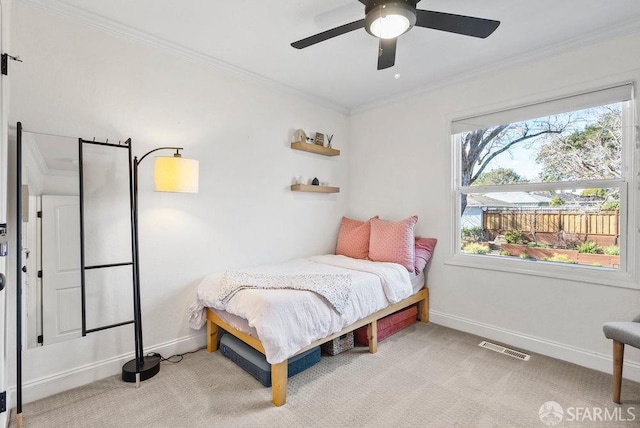 bedroom featuring crown molding, light carpet, a ceiling fan, baseboards, and visible vents