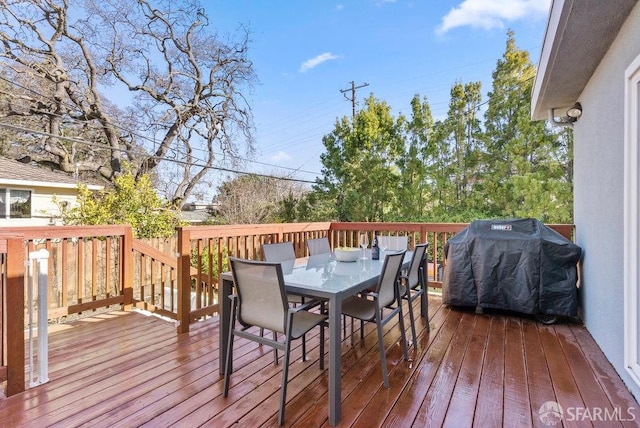 deck featuring grilling area and outdoor dining space