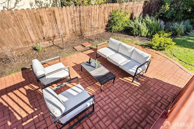 view of patio featuring fence and an outdoor living space