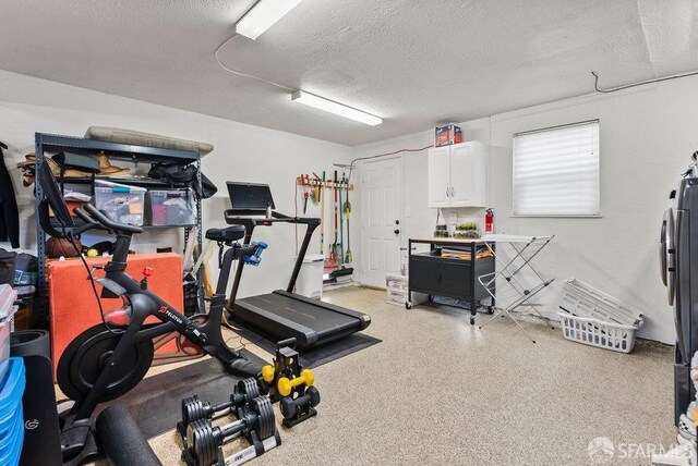 exercise room with a textured ceiling