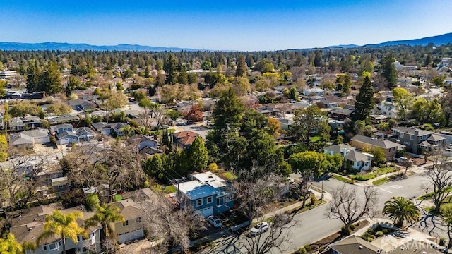 birds eye view of property featuring a mountain view, a residential view, and a forest view