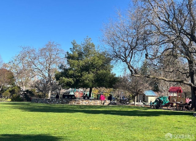 surrounding community featuring a lawn and playground community