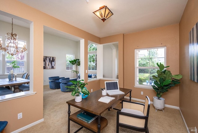 carpeted office space featuring baseboards and a notable chandelier