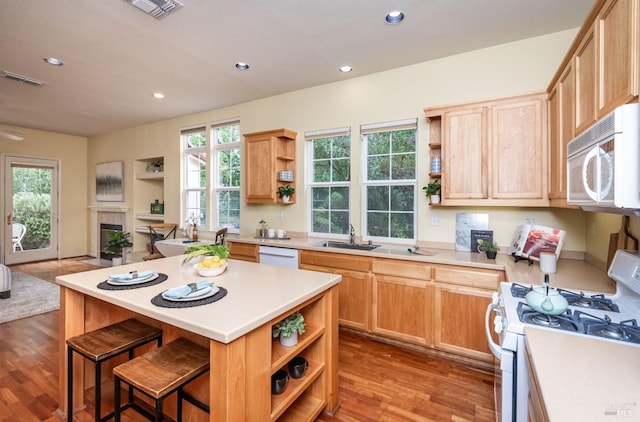kitchen with open shelves, white appliances, wood finished floors, and visible vents