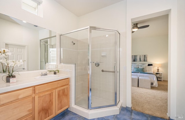 ensuite bathroom with connected bathroom, ceiling fan, a shower stall, and vanity