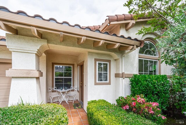 view of exterior entry with stucco siding