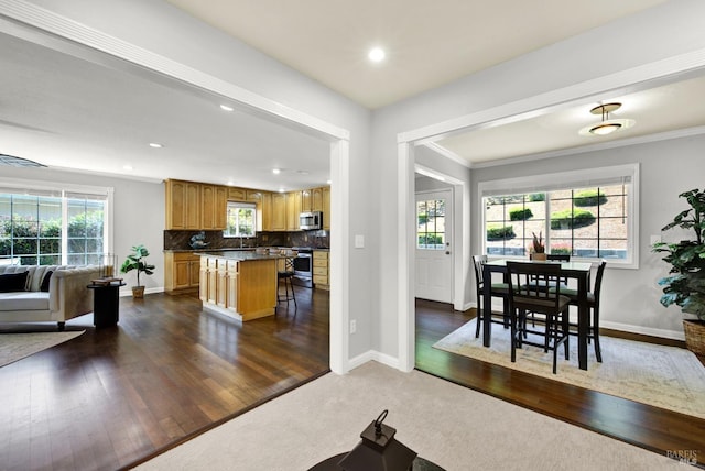 dining area with baseboards, ornamental molding, recessed lighting, and dark wood-type flooring