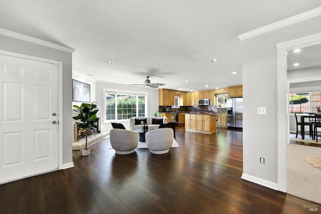 dining space with crown molding, dark wood-style flooring, and a wealth of natural light