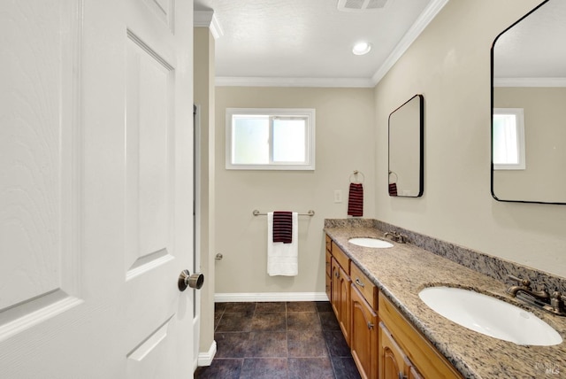 full bath featuring crown molding, baseboards, and a sink
