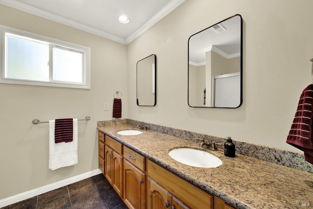 bathroom featuring crown molding, double vanity, baseboards, and a sink