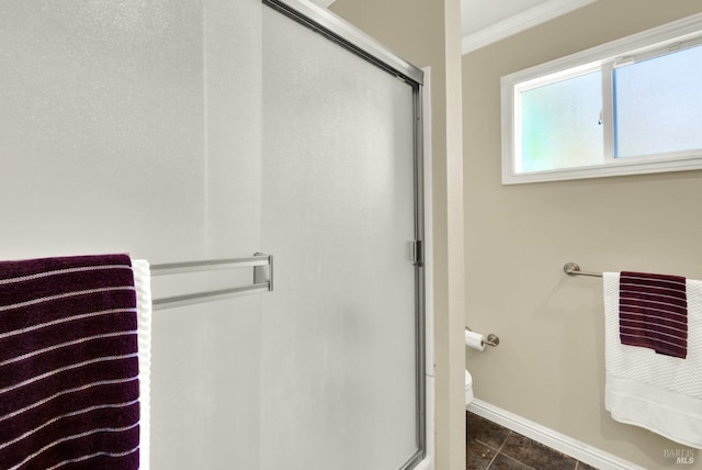 full bathroom featuring crown molding, baseboards, a shower stall, and tile patterned floors