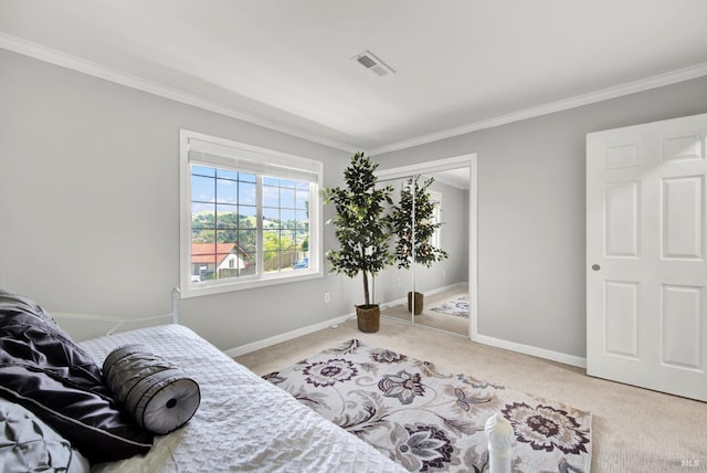 carpeted bedroom with baseboards, ornamental molding, and visible vents