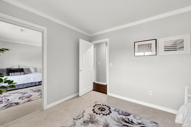 bedroom featuring carpet flooring, crown molding, visible vents, and baseboards