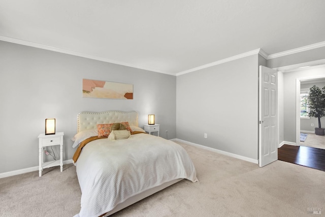 carpeted bedroom with crown molding and baseboards