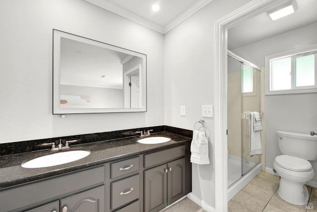 bathroom featuring toilet, a sink, and a stall shower