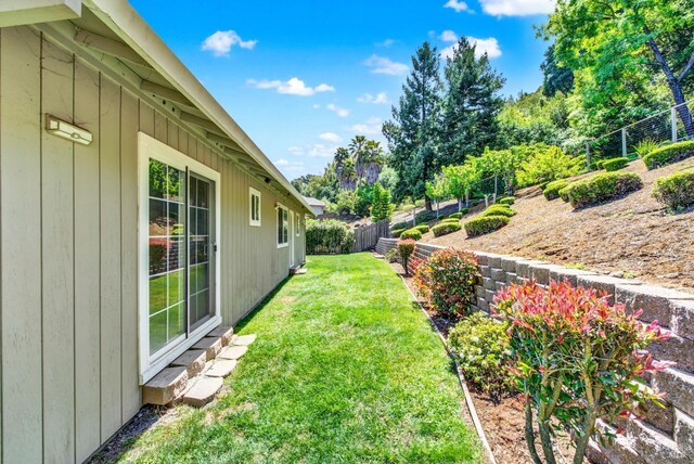view of yard with fence and entry steps
