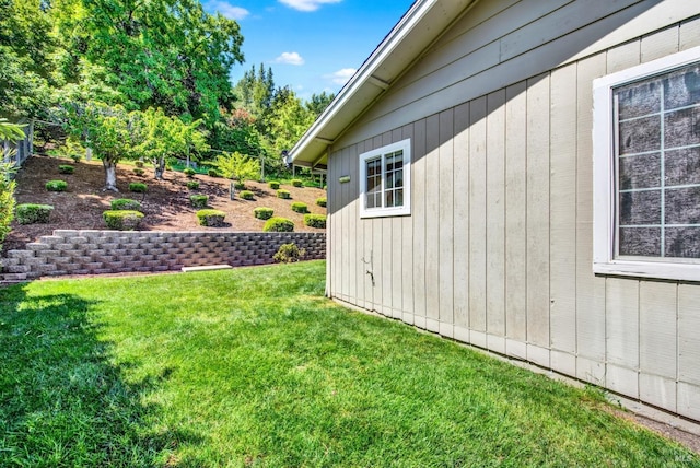 view of side of home with a lawn