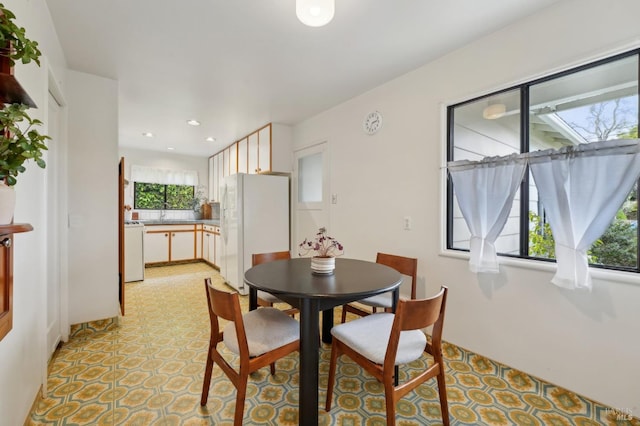 dining space with light floors and recessed lighting