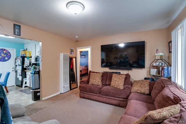 living area featuring baseboards, carpet floors, and a heating unit