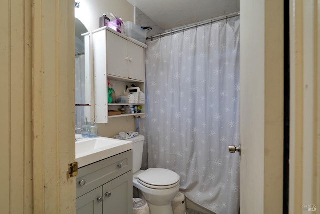 bathroom with a shower with shower curtain, toilet, and vanity
