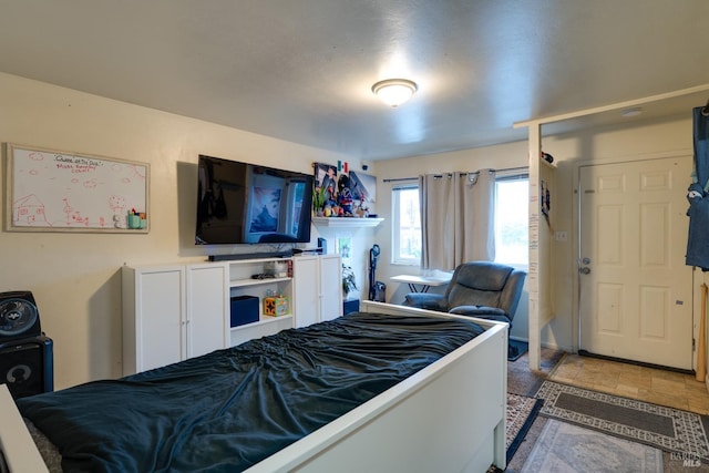 bedroom featuring stone finish floor