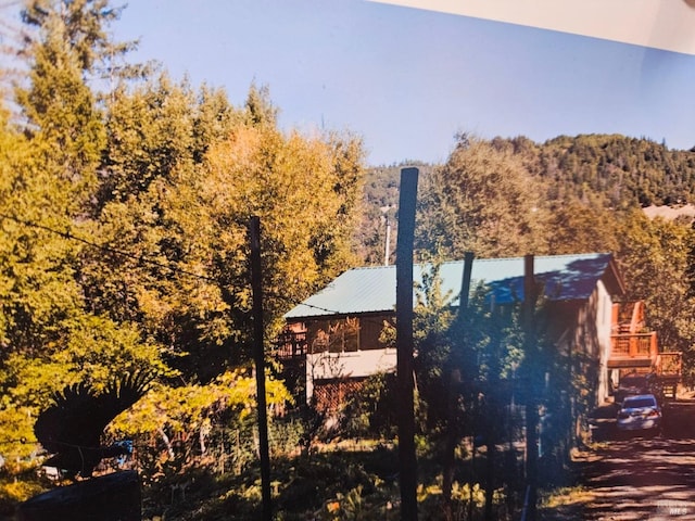 51211 Dunham Rd, Laytonville, CA 95587 - view of home's exterior with a wooded view and metal roof