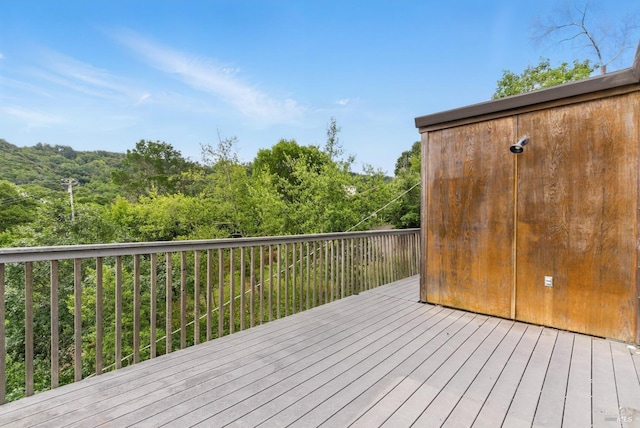 wooden terrace with a wooded view
