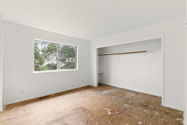unfurnished bedroom featuring a closet and visible vents