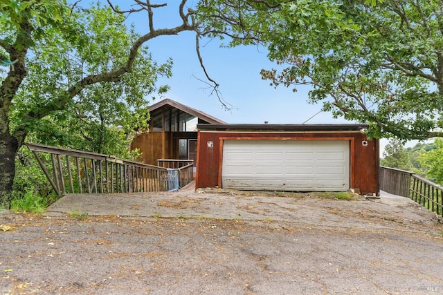 view of front of house featuring a garage and fence