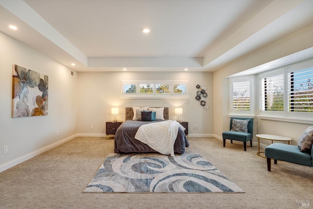 bedroom featuring a raised ceiling, recessed lighting, baseboards, and carpet floors