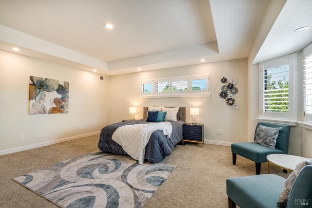 bedroom featuring recessed lighting, carpet floors, baseboards, visible vents, and a raised ceiling