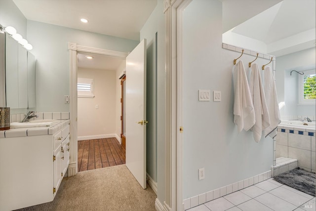 full bath with baseboards, recessed lighting, and vanity