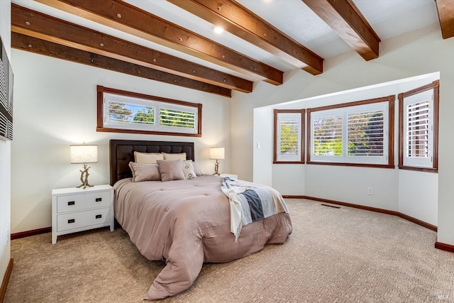 carpeted bedroom featuring multiple windows, beamed ceiling, and baseboards