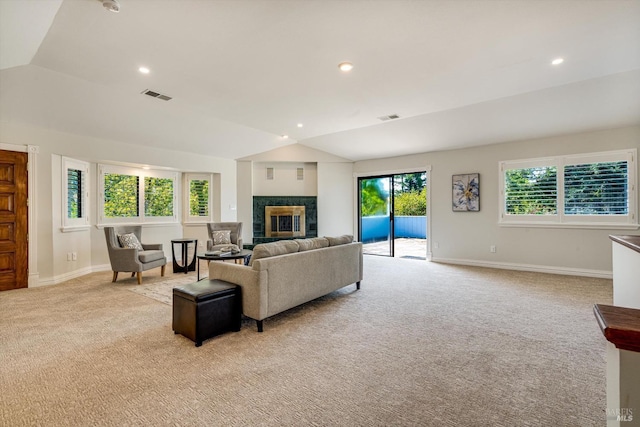 living area featuring visible vents, baseboards, vaulted ceiling, and light carpet