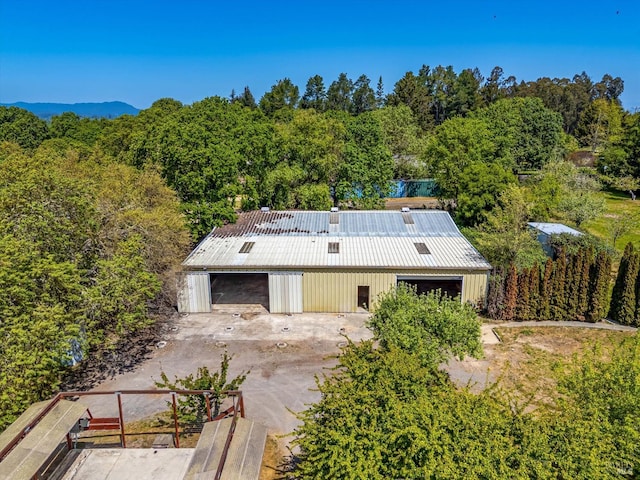birds eye view of property with a wooded view