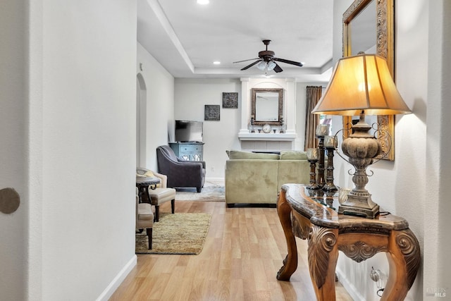 8724 Windsor Rd, Windsor, CA 95492 - hallway featuring a raised ceiling, arched walkways, recessed lighting, baseboards, and light wood-type flooring