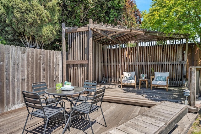 deck with outdoor dining area and fence