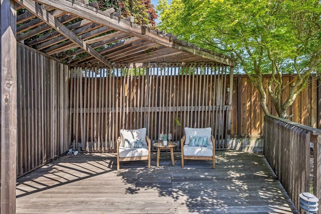 view of patio / terrace featuring fence, a wooden deck, and a pergola